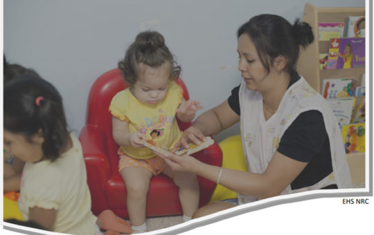 a provider cares for a young toddler seated in a child-size red armchair.