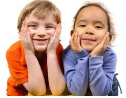 Two young, smiling children lean on their elbows with their faces in their hands.