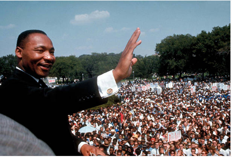 Dr. Martin Luther King Jr. giving his "I Have a Dream" speech and waving to the crowd.