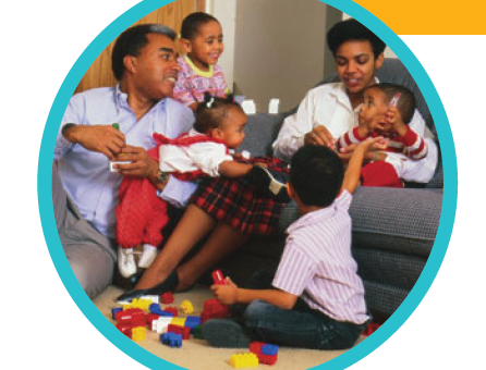 A mom and dad play with blocks to teach their four young children about shapes.