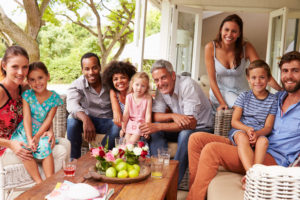 a diverse family sits on a porch