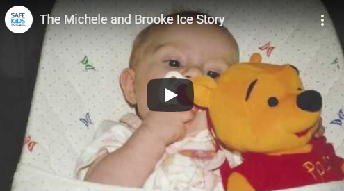 video screenshot of infant in crib holding Winnie the Pooh doll