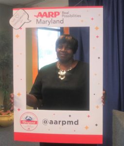 Grandmother holding AARP Maryland photo border.