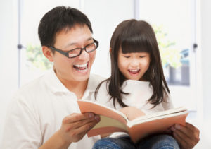 Father and daughter reading together