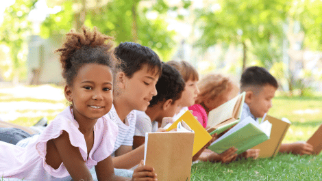 Summer Stride featuring children reading outdoors.